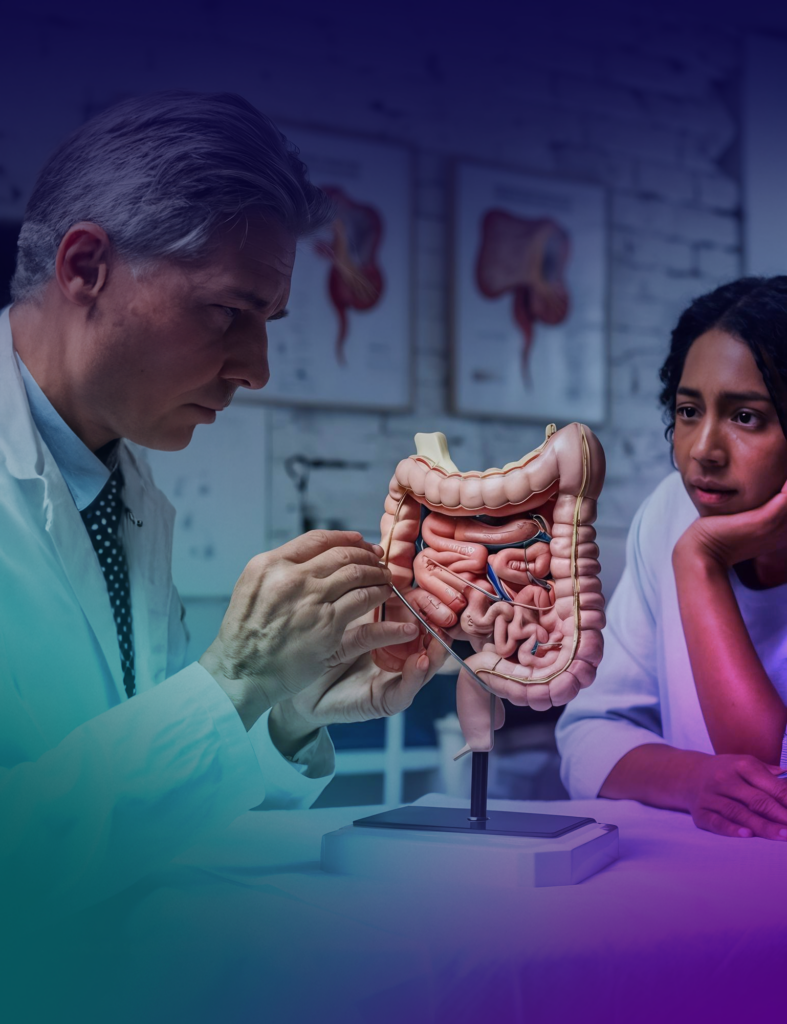 Doctor explaining human digestive system model.
