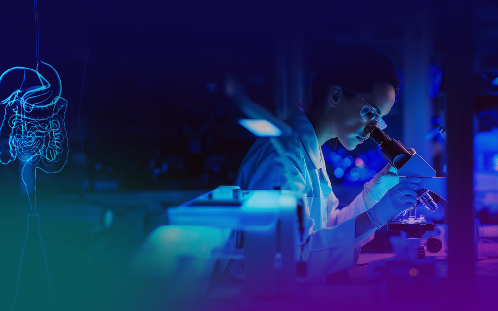 Scientist examining sample under microscope.