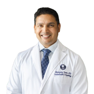 Smiling male doctor in white coat.